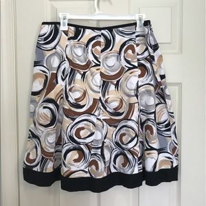 Knee-length skirt with black and brown swirls.