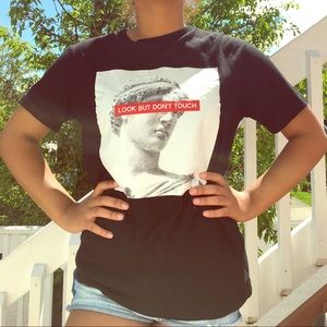 A tee shirt with art and a saying