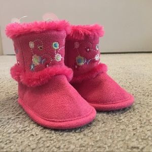 Absorba brand fuschia crib shoes with flowers.