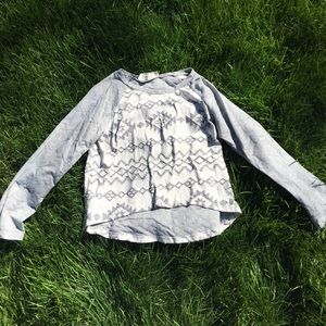 Asymmetrical long sleeved cropped Aztec print top