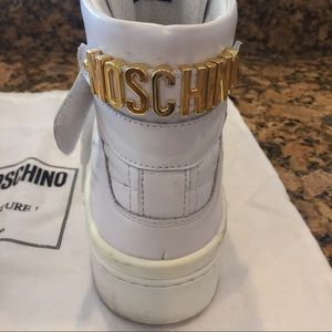 Women's white Moschino high top sneakers gold logo