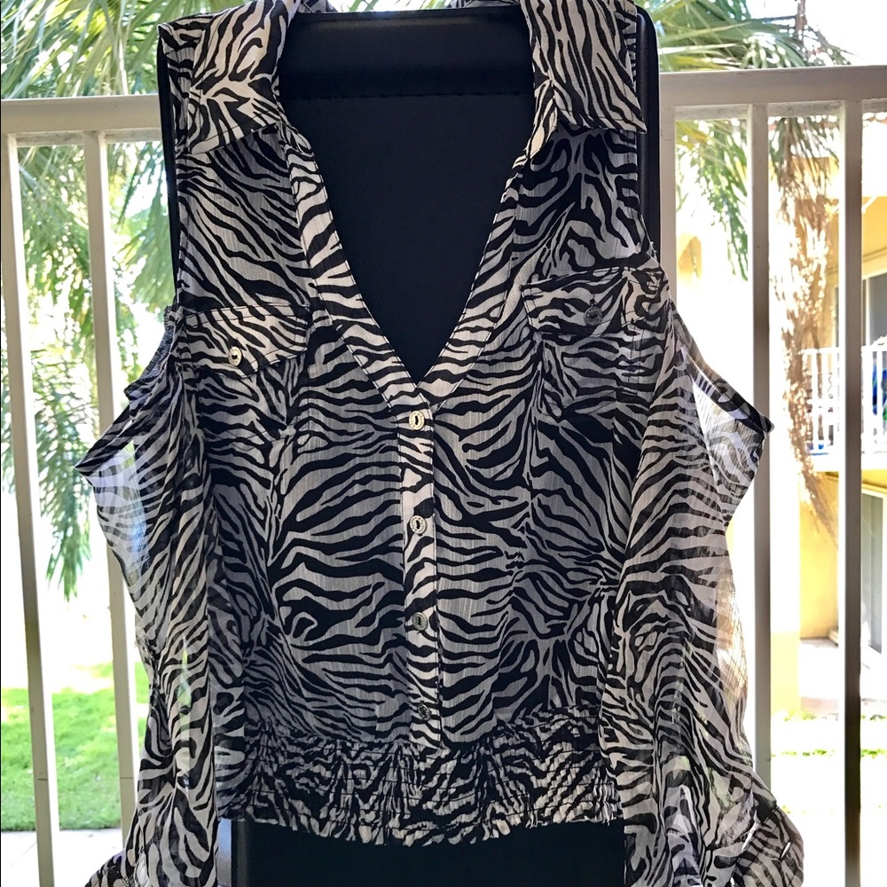 It is an open shoulder blouse with a zebra print