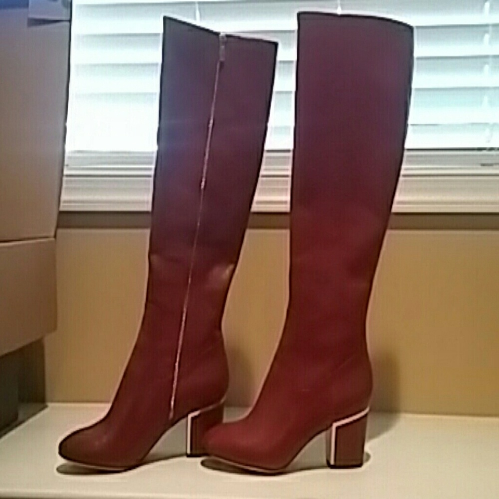 New knee high red leather boots. Never worn.