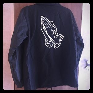 Black wind breaker with praying hands