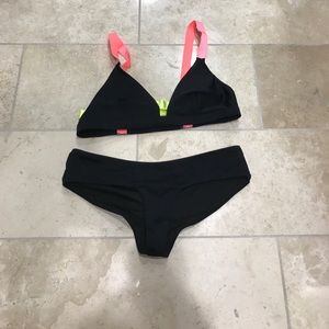 Cheeky black bottom and neon top bikini