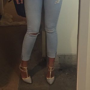 Nude heels with studs across ankle straps.