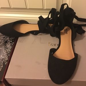 Lace up black flats.