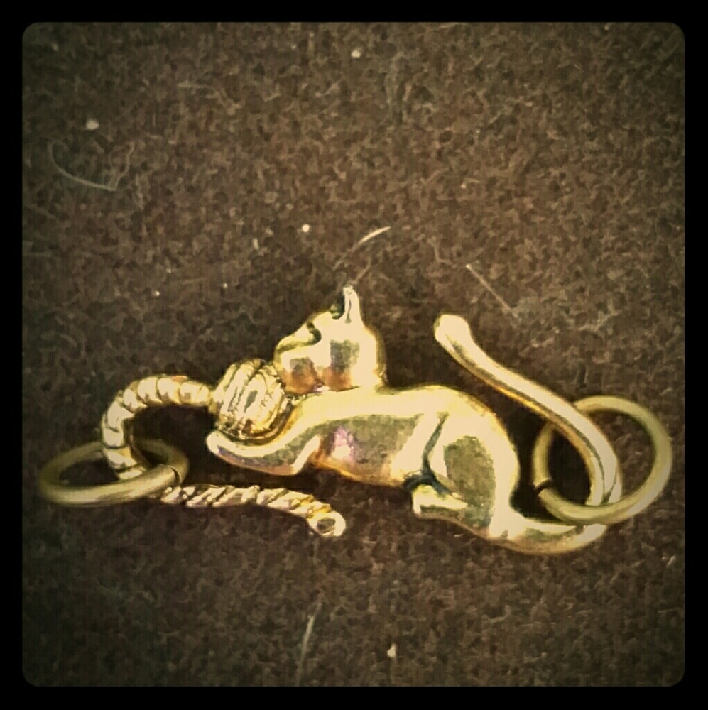 Cat playing w/yarn charm or exstender.