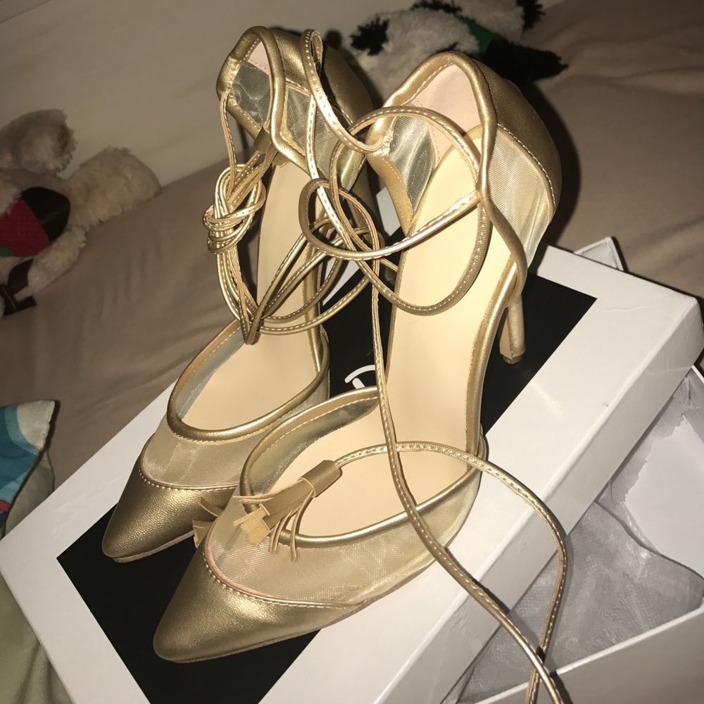 Gold kitty toe stiletto heel.