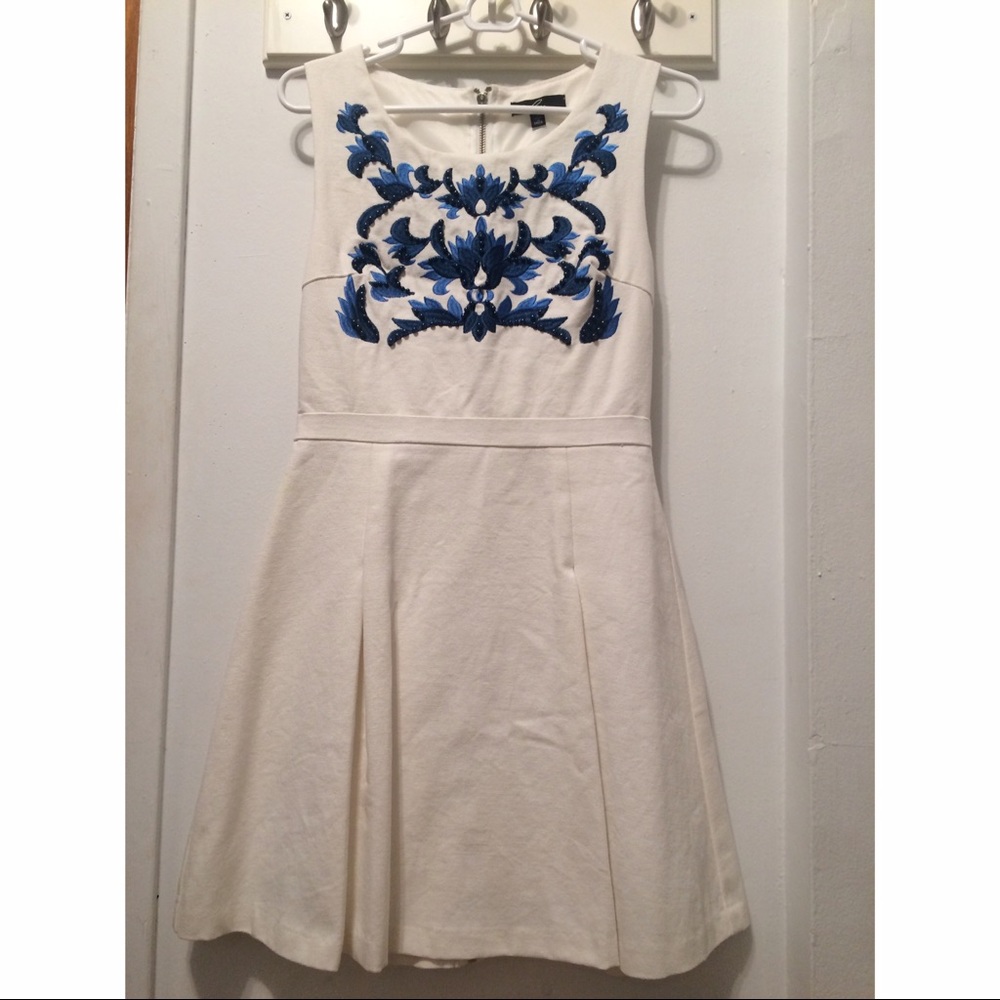 White cocktail dress embellished with blue beading