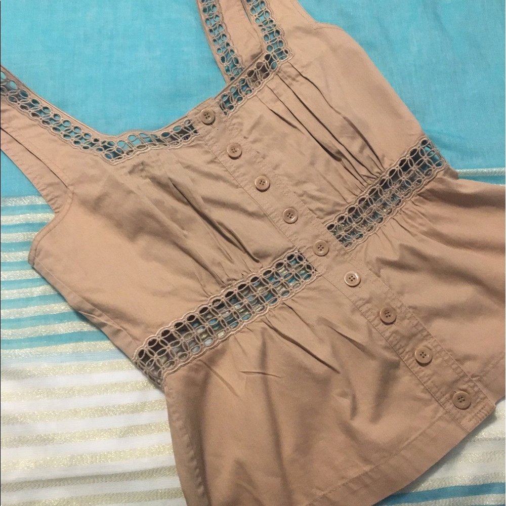 Tan top with detail on waist and strap.