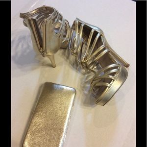 Metallic zip back platform stilettos & gold clutch
