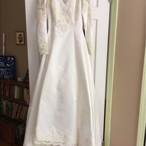 Wedding gown: ivory, size 6. Train bustles.