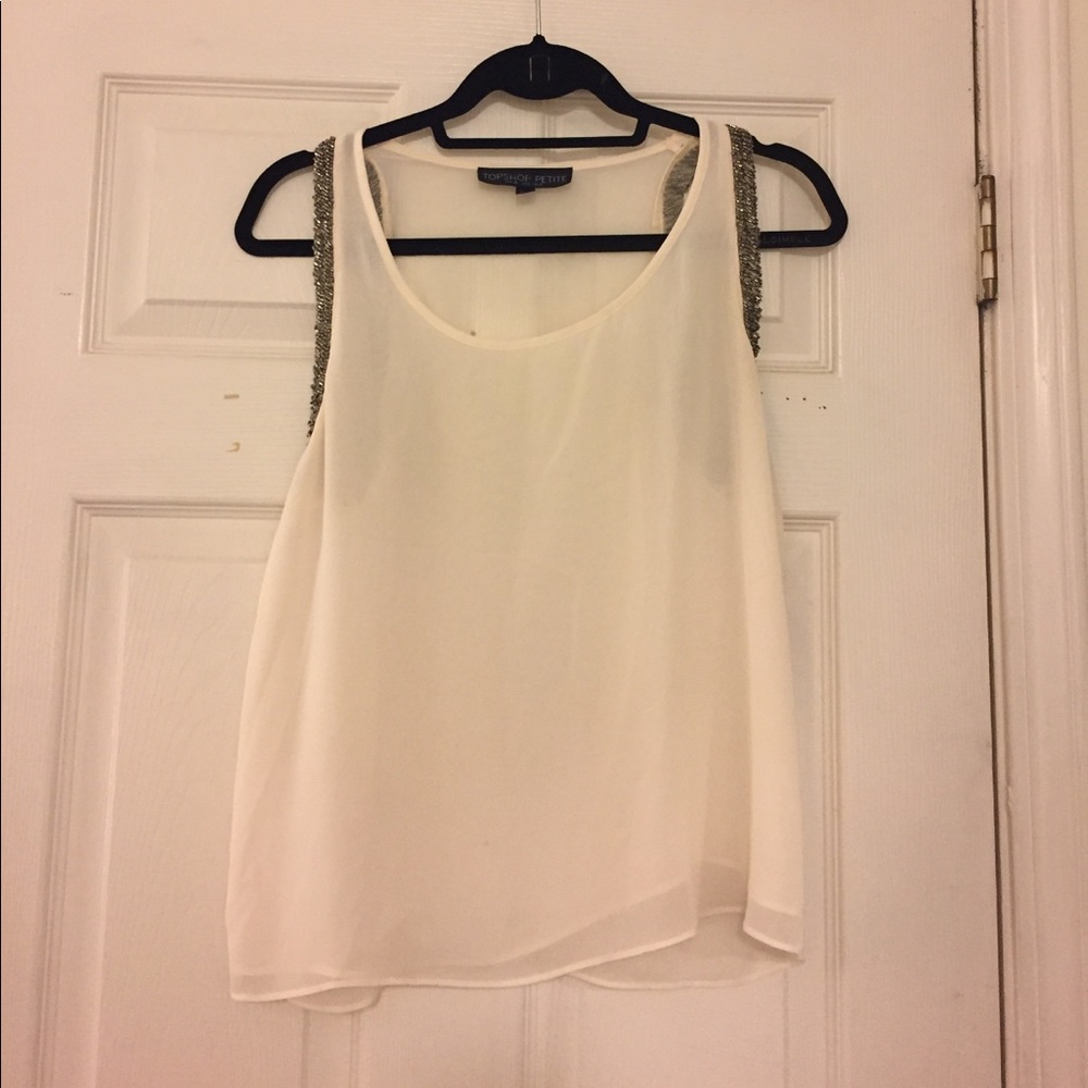 White blouse with beaded detail around the arms