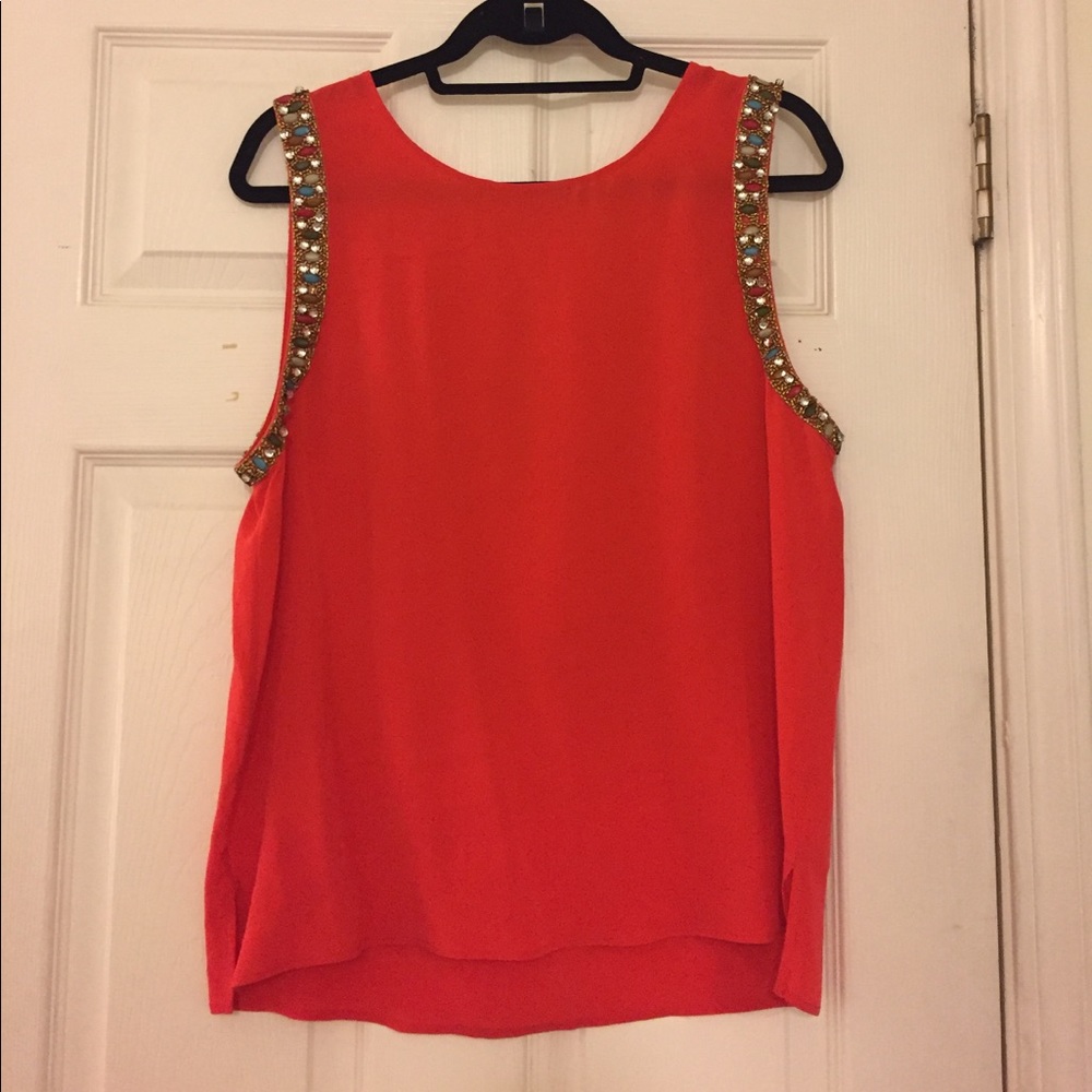 Red silk blouse with beaded detail around the arms