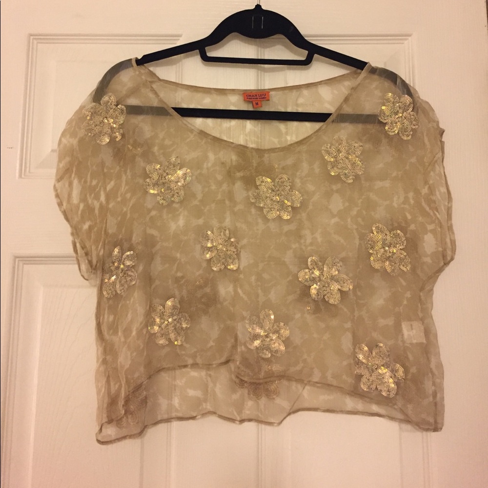 Delicate beige blouse with sequin flowers