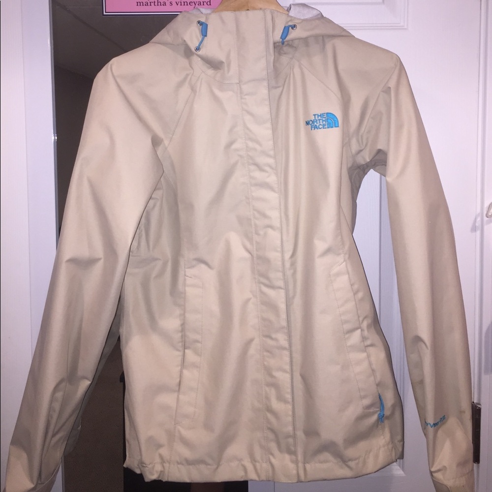 Tan/cream with blue lettering North Face rain coat
