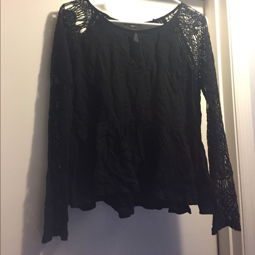 Black peplum blouse with lace sleeves.