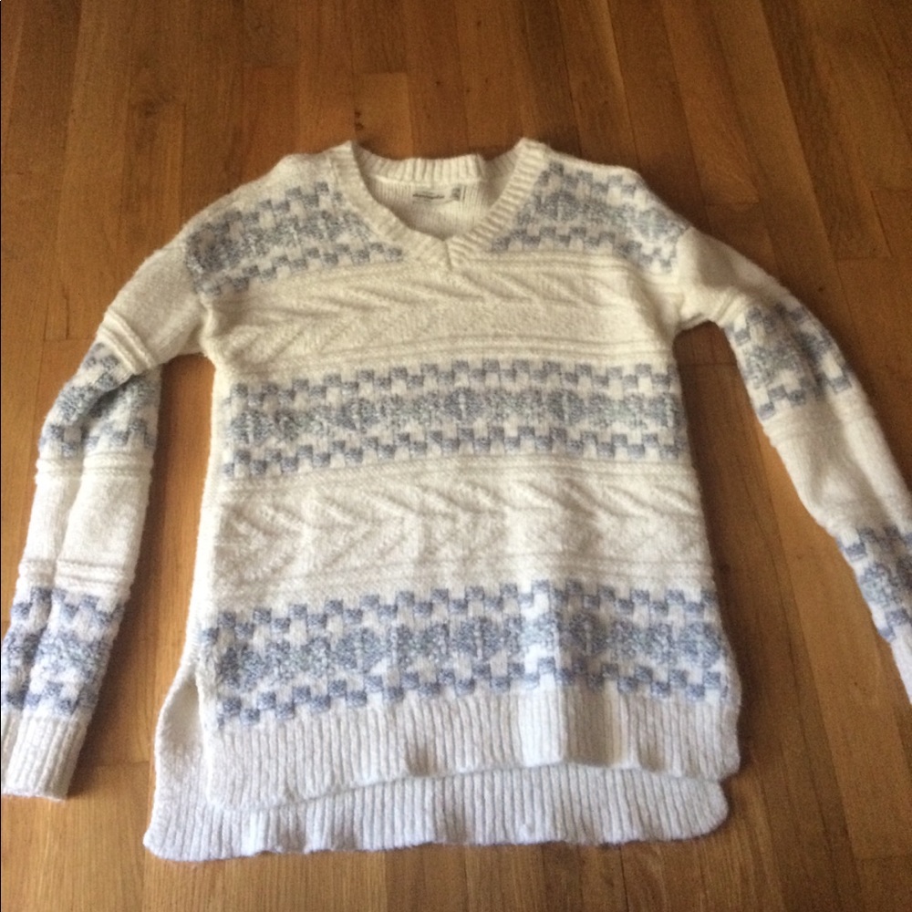 A light blue and white sweater