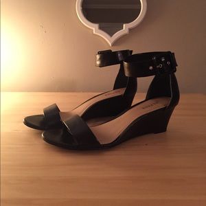 Black low wedge sandal with ankle buckle