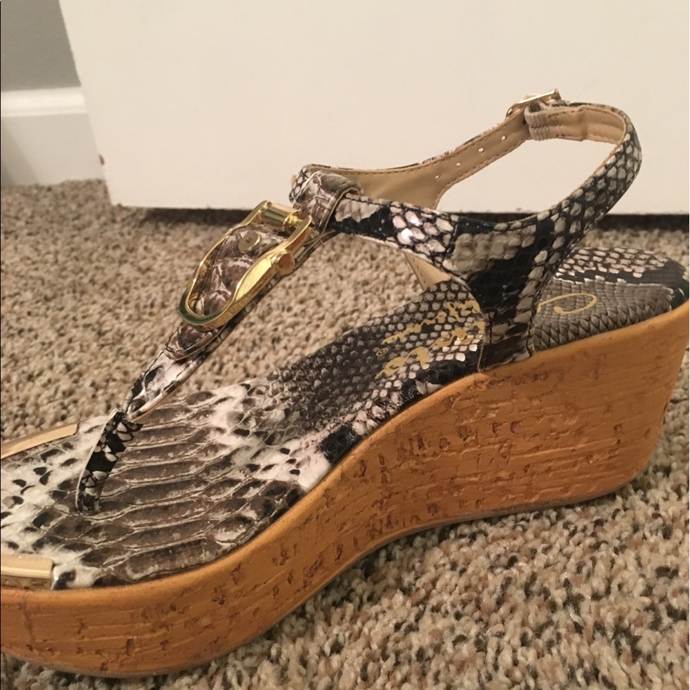 Callisto snake print sandals with gold buckles.