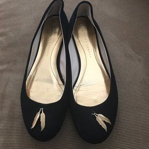 Sued black flats with gold feather detailing