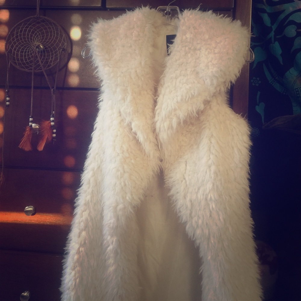 Long white faux fur vest.
