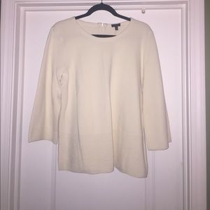 Cream top with zipper.