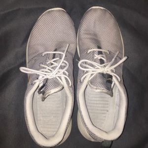 Grey and gold Nike roshes