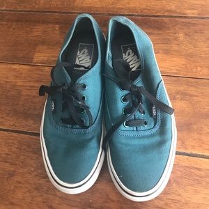 Vans in a blue green color.