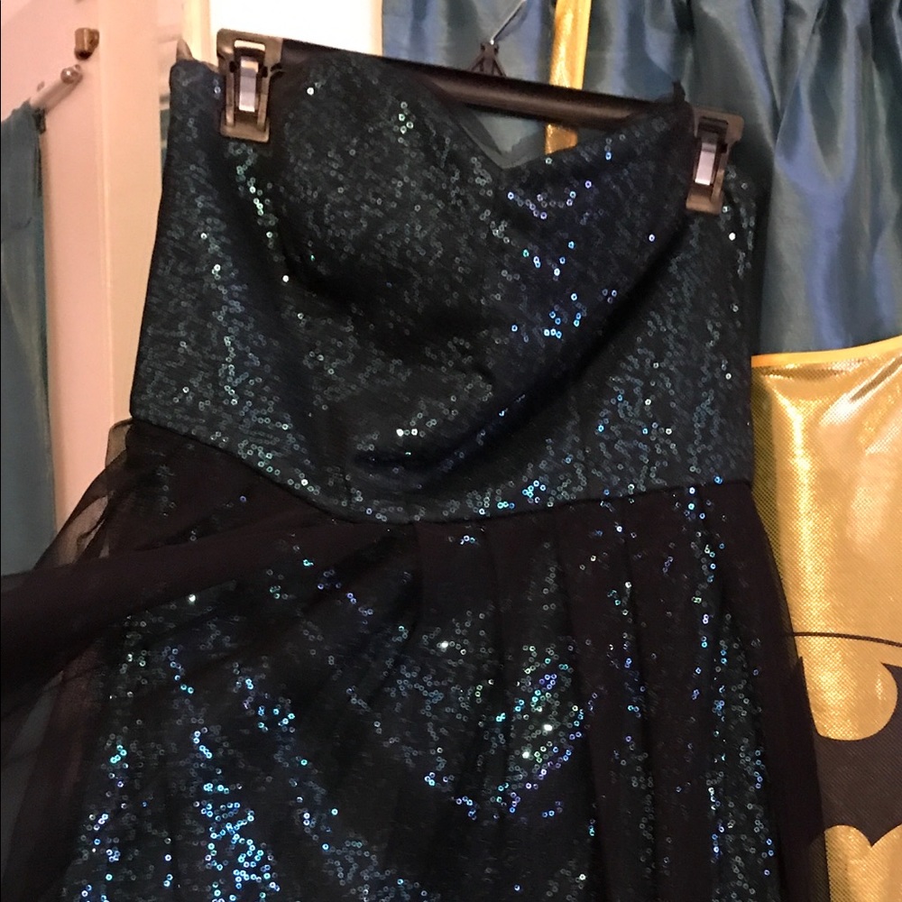Sleeveless, aqua color sequence dress.