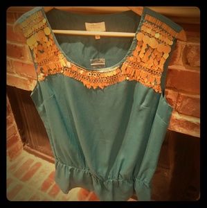 Turquoise blue top with gold leaf details.
