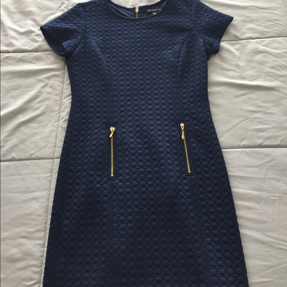 Navy blue dress with gold zippers in the front