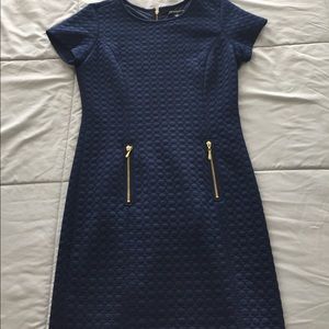 Navy blue dress with gold zippers in the front