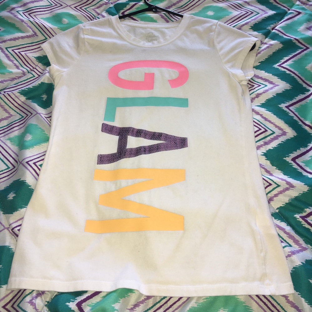A white tee with the words "GLAM" on it