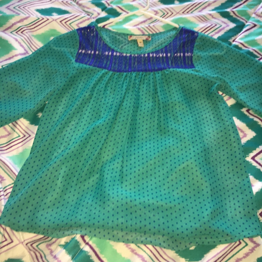 A blue blouse with blue polka-dots