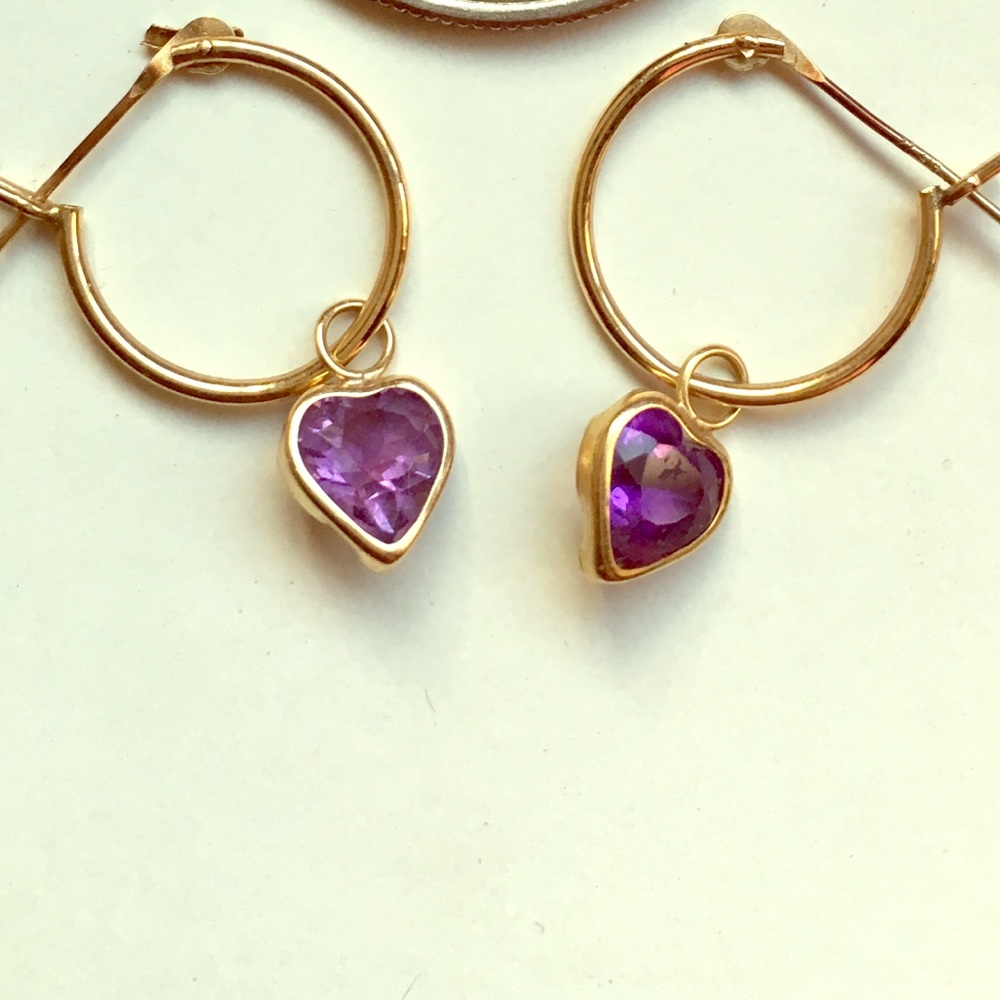 Gold hoop earrings with small purple stone hearts