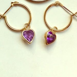 Gold hoop earrings with small purple stone hearts