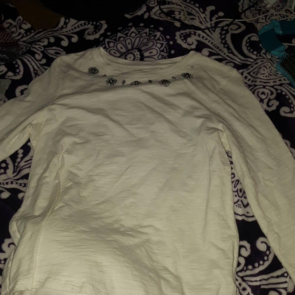 This cute cream shirt with jewels at the top