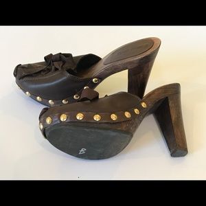 Brown lace-up mules with brass studs.  Miu Miu