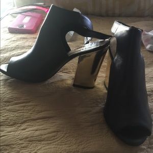 Black with a gold heel peep heels
