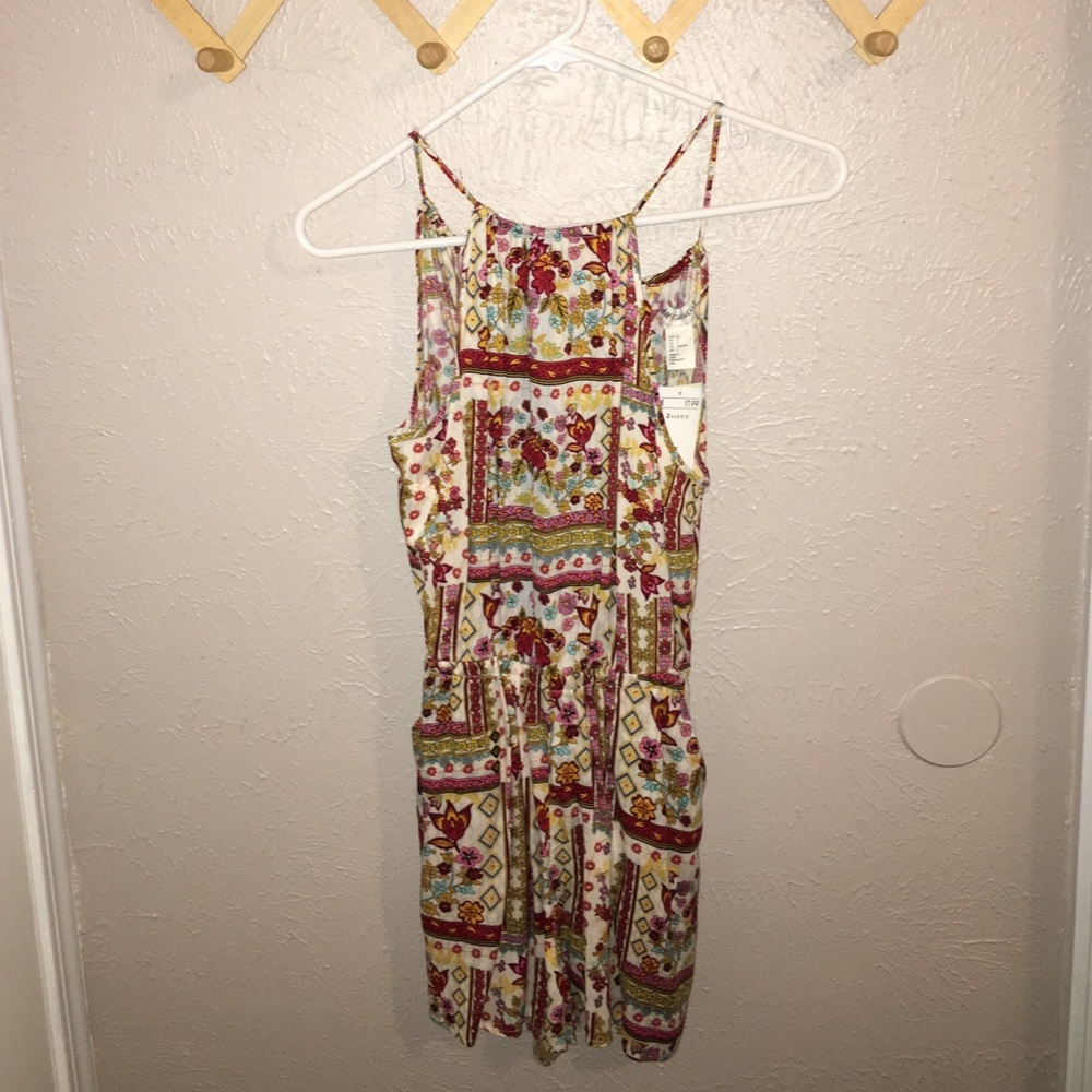 never worn, open back romper