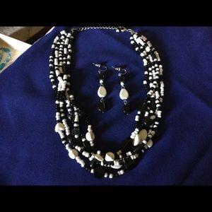 Necklace set one of the earrings has a skint place