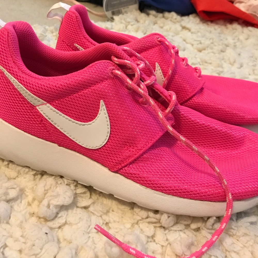 Bright pink Nike Roshes
