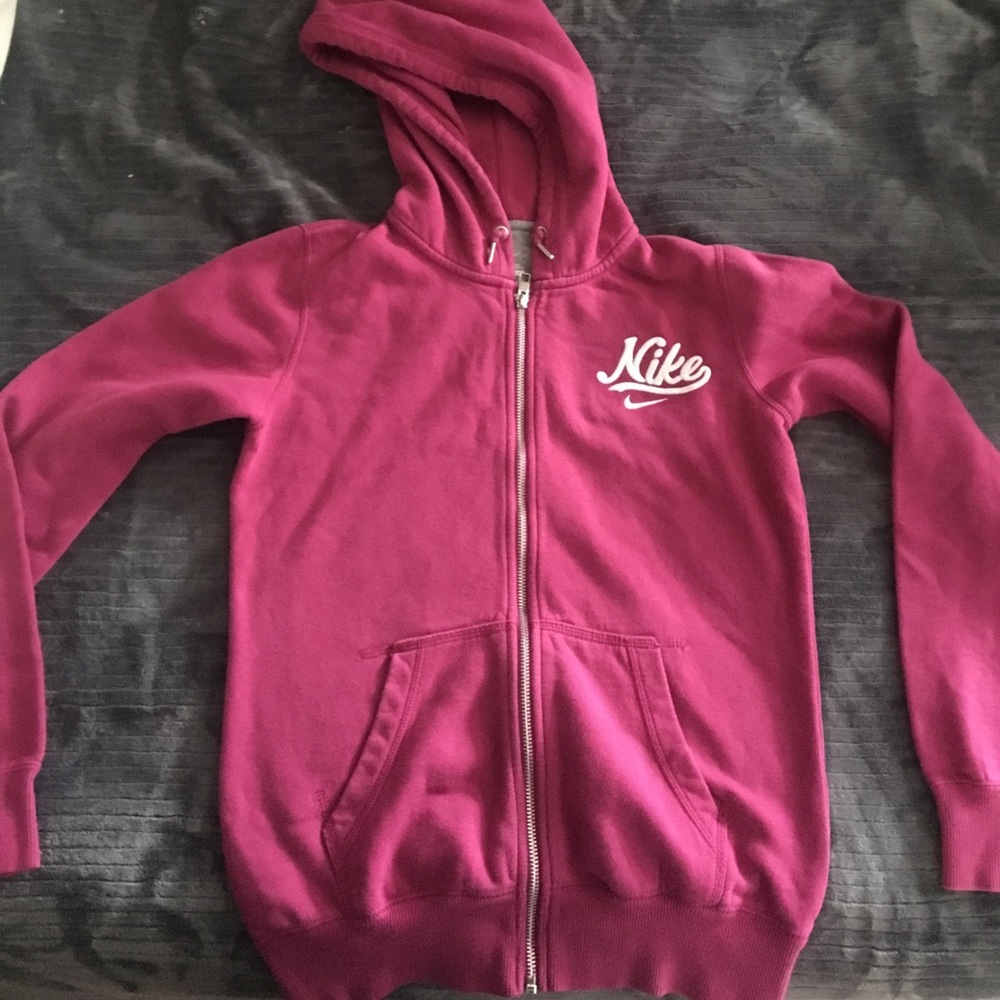 Magenta women's zip up Nike hoodie.