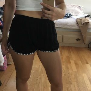 High waisted black shorts with flowers on bottom