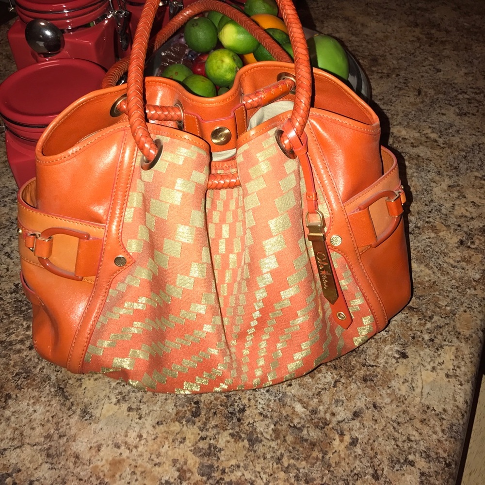 Orange, Cole Haan purse.