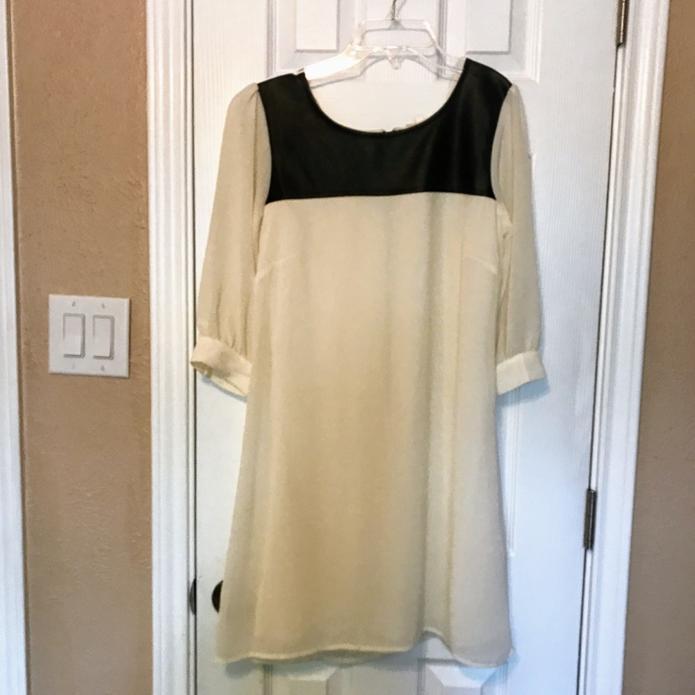 White Babydoll Dress with Black Leather accent.