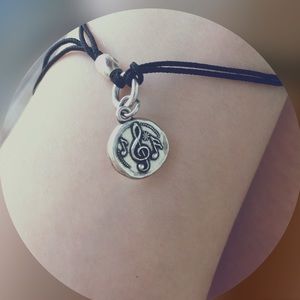 Black bracelet with musical note detail