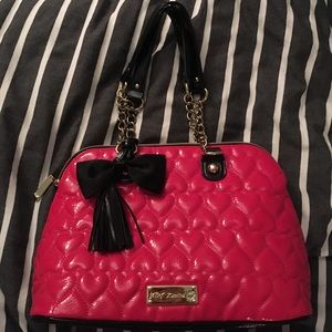 Betsey Johnson medium-sized pink handbag.